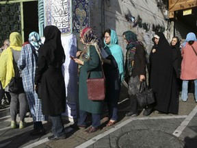 Iranian voters enter a polling station for the presidential and municipal councils elections in Tehran, Iran, Friday, May 19, 2017. Iranians began voting Friday in the country's first presidential election since its nuclear deal with world powers.