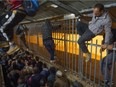 Cutting in line, Palestinian workers scale security fences at Checkpoint 300 to enter Jerusalem from Bethlehem.