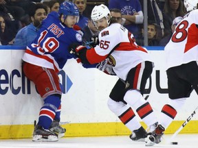 Erik Karlsson, right, of the Ottawa Senators battles with Jesper Fast of the New York Rangers during Game 4 action in their Eastern Conference semifinal Thursday in New York. Karlsson was forced out of the game with an injured foot after two periods in what turned out to be a 4-1 loss for the Sens. The series is tied at 2-2 heading back to Ottawa for Game 5 on Saturday.