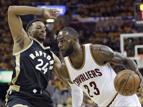 Cleveland Cavaliers forward LeBron James (right) drives against Toronto Raptors guard Norman Powell on May 3.
