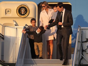 Ivanka Trump and husband Jared Kushner walk off Air Force One with their children at Palm Beach International airport.
