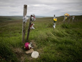 A plaque in memory of Keith Bennett and his mother Winnie Johnson sits next to floral tributes overlooking Saddleworth Moor where the body of  Bennett may be buried  in Saddleworth, United Kingdom.