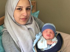 Afraa Bilal holds her newborn son, Justin Trudeau Adam Bilal.