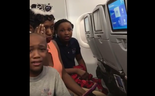 A screenshot of a video where the family is distraught about flight attendant's dispute with them over a cake. Police was called into the plane.