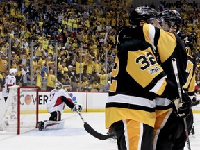 Pittsburgh Penguins forward Matt Cullen (right) celebrates with defenceman Mark Streit (32) after scoring against the Ottawa Senators on May 21.