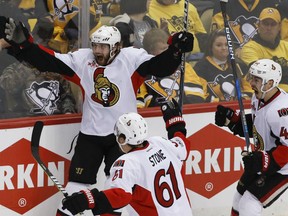 Ottawa Senators' Bobby Ryan, left, celebrates with teammates Mark Stone and Jean-Gabriel Pageau after scoring the game-winning goal in overtime against the Penguins in  Game 1 of the Eastern Conference final in Pittsburgh on Saturday night.