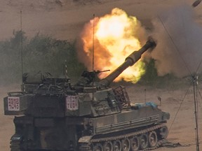 In this Monday, May 22, 2017 photo, South Korean army's K-55 self-propelled howitzer fires during the annual exercise in Paju, near the border with North Korea, South Korea. South Korea's military said Tuesday, May 23, 2017, it fired warning shots at an unidentified object flying south.