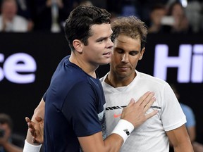 Spain's Rafael Nadal, right, is congratulated by Canada's Milos Raonic, after winning their quarter-final match at the Australian Open on Wednesday, Jan. 25, 2017.