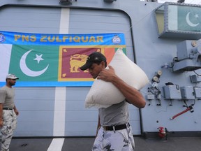 Pakistan Navy soldiers of PNS Zulfiquar unload relief materials in order to use in the flood affected areas in Colombo, Sri Lanka, Tuesday, May 30, 2017. Mudslides have become common during Sri Lanka's summer monsoon season as forests across the tropical Indian Ocean island nation have been cleared for export crops such as tea and rubber.