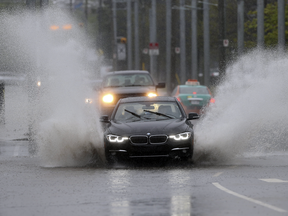 Traffic struggles through pooling water on Eastern Ave. on May 25, 2017 following a storm.