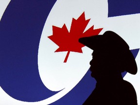 A forum visitor is silhoutetted in front of a projected logo before a Conservative party leadership candidate forum at the Deerfoot Inn and Casino in Calgary, Alta. on Wednesday March 1, 2017