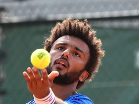 Maxime Hamou serves the ball to Pablo Cuevas during their first-round match at the French Open on May 29.