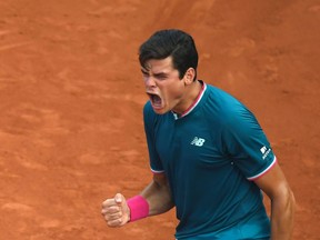 Milos Raonic yells during his match against Rogerio Dutra Silva at the French Open on May 31.