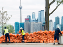 Workers stack sand bags along the Toronto Islands which are threatened by rising water levels on Friday, May 19, 2017.