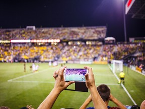 A fan takes a photo during a match between Columbus Crew SC and San Jose Earthquakes in Columbus, Ohio. Columbus won 2-0.