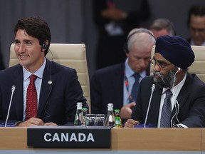 Justin Trudeau, Prime Minister of Canada, and Canadian Defense Minister Harjit Sajjan attend the meeting of the North Atlantic Council at the Warsaw NATO Summit on July 8, 2016 in Warsaw, Poland.