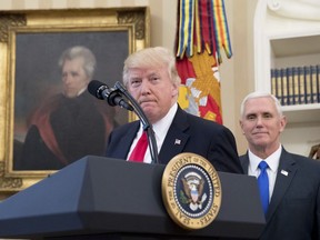 FILE - In this March 31, 2017 file photo, a portrait of former President Andrew Jackson hangs on the wall behind President Donald Trump, accompanied by Vice President Mike Pence, in the Oval Office at the White House in Washington. President Donald Trump made puzzling claims about Andrew Jackson and the Civil War in an interview, suggesting that he was uncertain about the origin of the conflict while claiming that Jackson was upset about the war that started more than a decade after his death.  (AP Photo/Andrew Harnik, File)