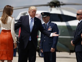 President Donald Trump and first lady Melania Trump with Col. Casey D. Eaton, Commander, 89th Airlift Wing, Andrews Air Force Base prepares to board Air Force One at Andrews Air Force Base, Md., Friday, May 19, 2017, for his first international trip as president