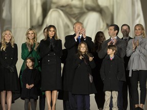 U.S. President Donald Trump applauds while standing with his family during the "Make America Great Again" Welcome Celebration concert at the Lincoln Memorial in Washington, D.C., on Thursday, Jan. 19, 2017.