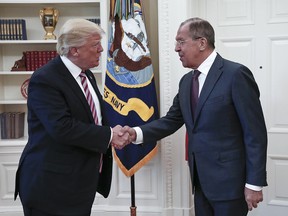 U.S. President Donald Trump, left, shakes hands with Russian Foreign Minister Sergey Lavrov in the White House in Washington, Wednesday, May 10, 2017. President Donald Trump on Wednesday welcomed Vladimir Putin's top diplomat to the White House for Trump's highest level face-to-face contact with a Russian government official since he took office in January.