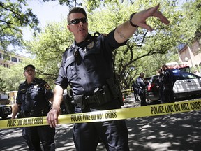 Law enforcement officers secure the scene after a fatal stabbing attack on the University of Texas campus Monday, May, 1, 2017.