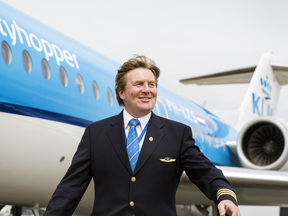 Dutch King Willem-Alexander in front of a KLM Cityhopper plane at Schiphol Airport, near Amsterdam, May 16, 2017.