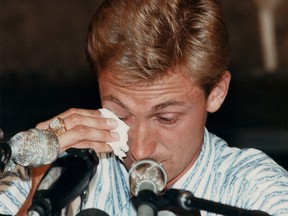 Wayne Gretzky wipes a tear as he tries to talk at the press conference at Molson House in Edmonton Alta., on Aug. 9, 1988 announcing that he was traded to the LA Kings from the Edmonton Oilers, shocking the sporting world.