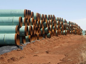 Miles of pipe ready to become part of the Keystone Pipeline are stacked in a field near Ripley, Okla