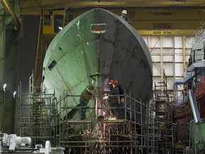 Technicians work on a hull at Halifax Shipyard in Halifax