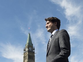Canadian Prime Minister Justin Trudeau leaves the stage after a flag raising ceremony on Parliament Hill in Ottawa, Wednesday June 14, 2017.
