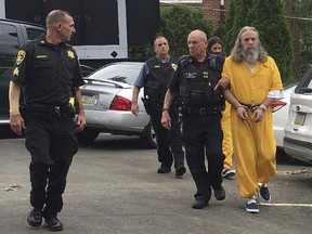 Lee Donald Kaplan, right, and Daniel Stoltzfus, back in yellow, are led to a preliminary hearing outside Bucks County Magisterial District in Feasterville, Pa. Aug. 2, 2016. Kaplan was convicted Tuesday, June 6, 2017, of sexually assaulting six girls in the same family.