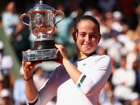 Jelena Ostapenko of Latvia celebrates shows off the French Open champion's trophy following her victory over Simona Halep of Romania on Day 14 of the 2017 French Open at Roland Garros on June 10, 2017 in Paris.