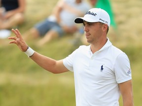 Justin Thomas acknowledges the crowd after making a birdie on the 17th green during the third round of the 2017 U.S. Open at Erin Hills on June 17, 2017.