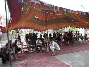 In this photo taken on Tuesday, Jun 6, 2017, protesters sit under a tent as they listen during a long protest against insecurity in Kabul, Afghanistan. One person was killed and six were wounded when Afghan security forces on Monday night moved in to dismantle the last remaining tent set up by protesters rallying in the capital, Kabul. (AP Photos/Massoud Hossaini)