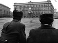 This undated file picture shows Soviet policemen standing guard in front of the KGB building in Moscow, with a portrait of Vladimir Lenin