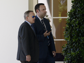 White House Press Secretary Sean Spicer (L) and White House Director of Social Media Daniel Scavino Jr., walk to the West Wing. Scavino has received a letter of admonishment for improper use of Twitter.