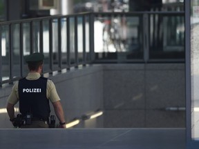 A police officer secures the entrance to the train station after a shooting in an S-Bahn station in Unterfoehring, a northeastern suburb of the Bavarian city of Munich, on June 13, 2017.