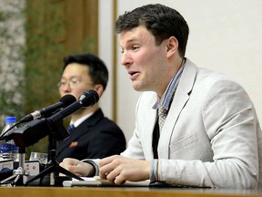 This file photo taken on February 29, 2016 and released by North Korea's official Korean Central News Agency (KCNA) on March 1, 2016 shows US student Otto Frederick Warmbier (R), who was arrested for committing hostile acts against North Korea, speaking at a press conference in Pyongyang.