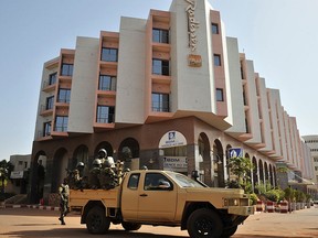 This file photo taken on November 21, 2015 shows Malian troops patrolling outside the Radisson Blu hotel in Bamako a day after the deadly jihadist siege at the luxury hotel.  Suspected jihadists are behind an attack on a tourist resort popular with Westerners on the edge of the Malian capital Bamako, a security ministry official told AFP on June 18, 2017.