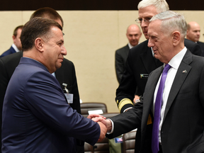 Ukraine's Minister of Defence and General of Army Stepan Poltorak (L) shakes hands with US Defense Minister James Mattis during a NATO Defense Council meeting at the NATO Headquarters in Brussels on June 29, 2017.