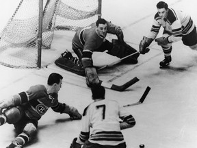 Jacques Plante, goalie of the Montreal Canadiens, and teammate Butch Bouchard (left) combine forces to prevent a goal by New York Rangers players Don Raleigh (#7) and Bill Ezinicki during the second period, Madison Square Garden, New York, February 27, 1955.
