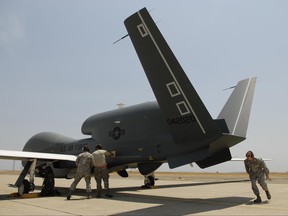 FILE - In a Monday, June 30, 2008, file photo, Beale Air Force Base Airmen work on an RQ-4 Global Hawk into its hangar at Beale Air Force Base in Yuba County, Calif. An RQ-4 Global Hawk crashed in a remote section of eastern California near Mt. Whitney. Edwards Air Force Base said in a statement that the unmanned surveillance aircraft was making a routine trip Wednesday, June 21, 2017, from Edwards to its usual home at Beale Air Force Base when it crashed for unknown reasons. (Chris Kaufman/The Appeal-Democrat via AP, File)