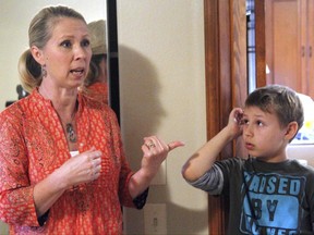 Alisa Landis, left, and her 11-year-old son, Zach, explain how a black bear crashed through Zach's bedroom window in Anchorage, Alaska, Friday, June 30, 2017. He said the bear broke through both a screen and the glass pane of a garden-level window on June 26, and left claw marks and blood on the wall as it scrambled to get back outside.