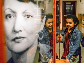 In this Thursday, Feb. 16, 2017, file photo, Peri Blair looks at a new permanent exhibit honoring Tlingit civil rights activist Elizabeth Peratrovich in Ketchikan, Alaska, following the unveiling of the exhibit and the naming of the Elizabeth Peratrovich Theater. Peratrovich, an Alaska Native woman whose passionate testimony is credited with swaying the Alaska Territorial Legislature into passing an anti-discrimination bill nearly 20 years before the Civil Rights Act of 1964, will be featured on a new $1 coin honoring Native American civil rights leaders. (Taylor Balkom/Ketchikan Daily News via AP, File)