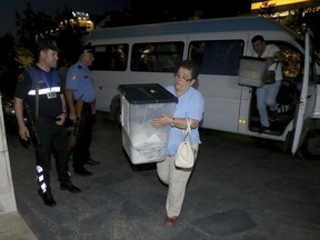 Albanian police accompany ballot boxes at the end of Albania's voting in the capital Tirana, Sunday, June 25, 2017.  Albanians voted Sunday in a general election with the country's two biggest political parties working together for membership of the European Union.(AP Photo/Hektor Pustina)