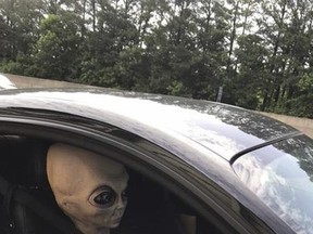 In this Sunday, June 25, 2017 photo provided by the Alpharetta Department of Public Safety an alien figure sits in the passenger seat of a vehicle that was pulled over north of Atlanta, Ga. (Alpharetta Department of Public Safety via AP)
