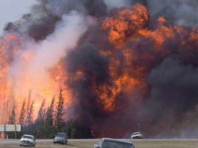 A giant fireball is visible as a wildfire rips through the forest by Highway 63, 16 kilometres south of Fort McMurray, Alta. on May 7, 2016. Researchers at the University of Calgary say smartphone emergency apps don't provide much of the information people need during a disaster. THE CANADIAN PRESS/Jonathan Hayward