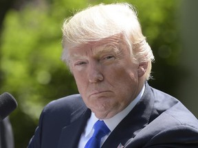 FILE - In this June 9, 2017, file photo, President Donald Trump listens during a news conference in the Rose Garden of the White House in Washington. A clear majority of Americans believe Trump has tried to interfere with the investigation into Russia's alleged election meddling and possible Trump campaign collusion, a new poll shows. Just one in five support his decision to oust James Comey from the FBI. (AP Photo/Susan Walsh, File)