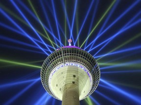 A June 26, 2017 photo shows of a light installation on the Rhine Tower during a rehearsal in Duesseldorf, Germany. The light installation promotes the start of the cycling race Tour de France  on Saturday July 1, 2017 in Duesseldorf. (David Young/dpa via AP)