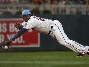 Minnesota Twins third baseman Miguel Sano dives for but misses a double hit by the Cleveland Indians' Jose Ramirez in the first inning of baseball game two of a doubleheader Saturday, June 17, 2017, in Minneapolis. (AP Photo/Bruce Kluckhohn)